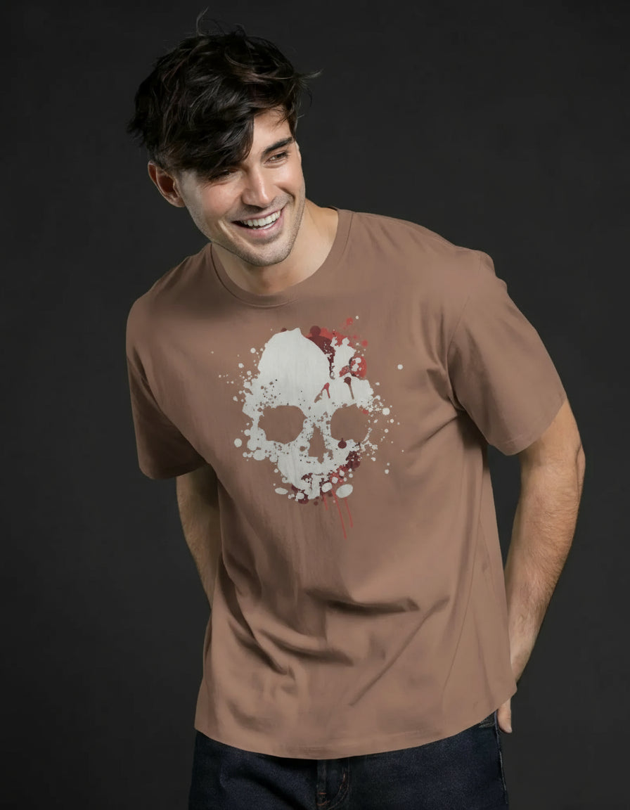 Man wearing a brown t-shirt with a skull design on a green background