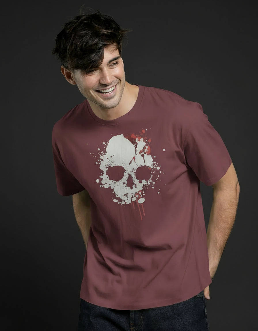 Man wearing a maroon t-shirt with a white skull design on a green background