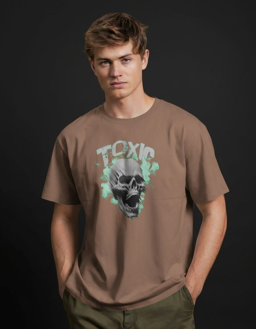 Person wearing a brown t-shirt with a graphic design on an orange background